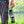 Load image into Gallery viewer, A man holding a bottle with three stickers on it
